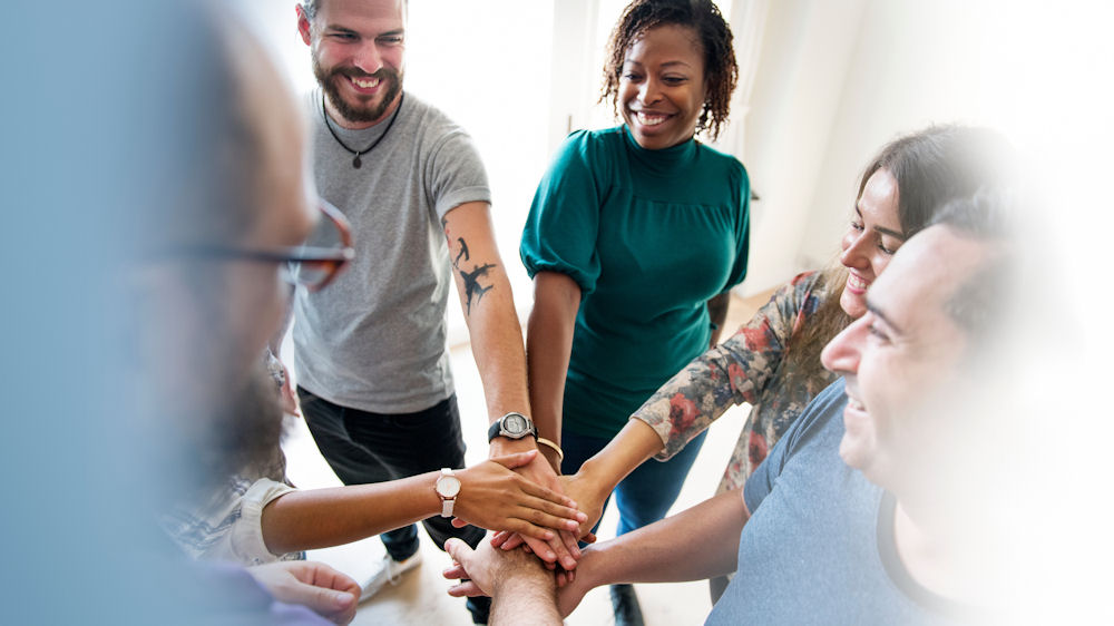 end of group therapy session, people putting hands in a circle