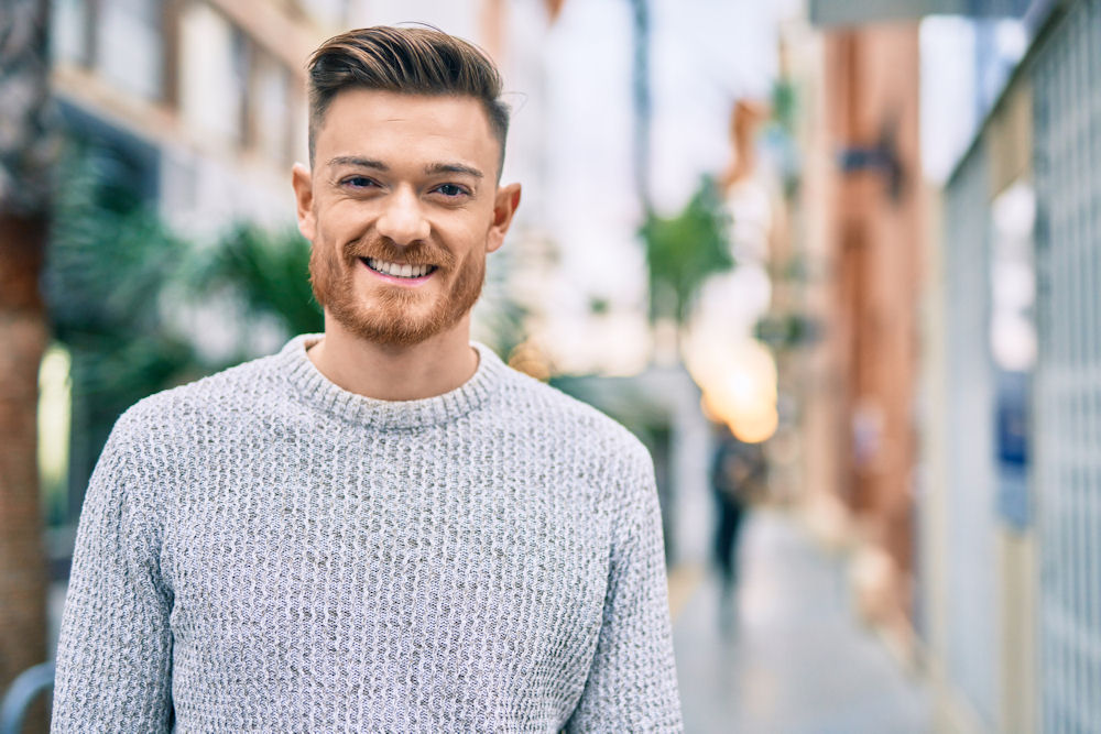 man in recovery standing outdoors and smiling